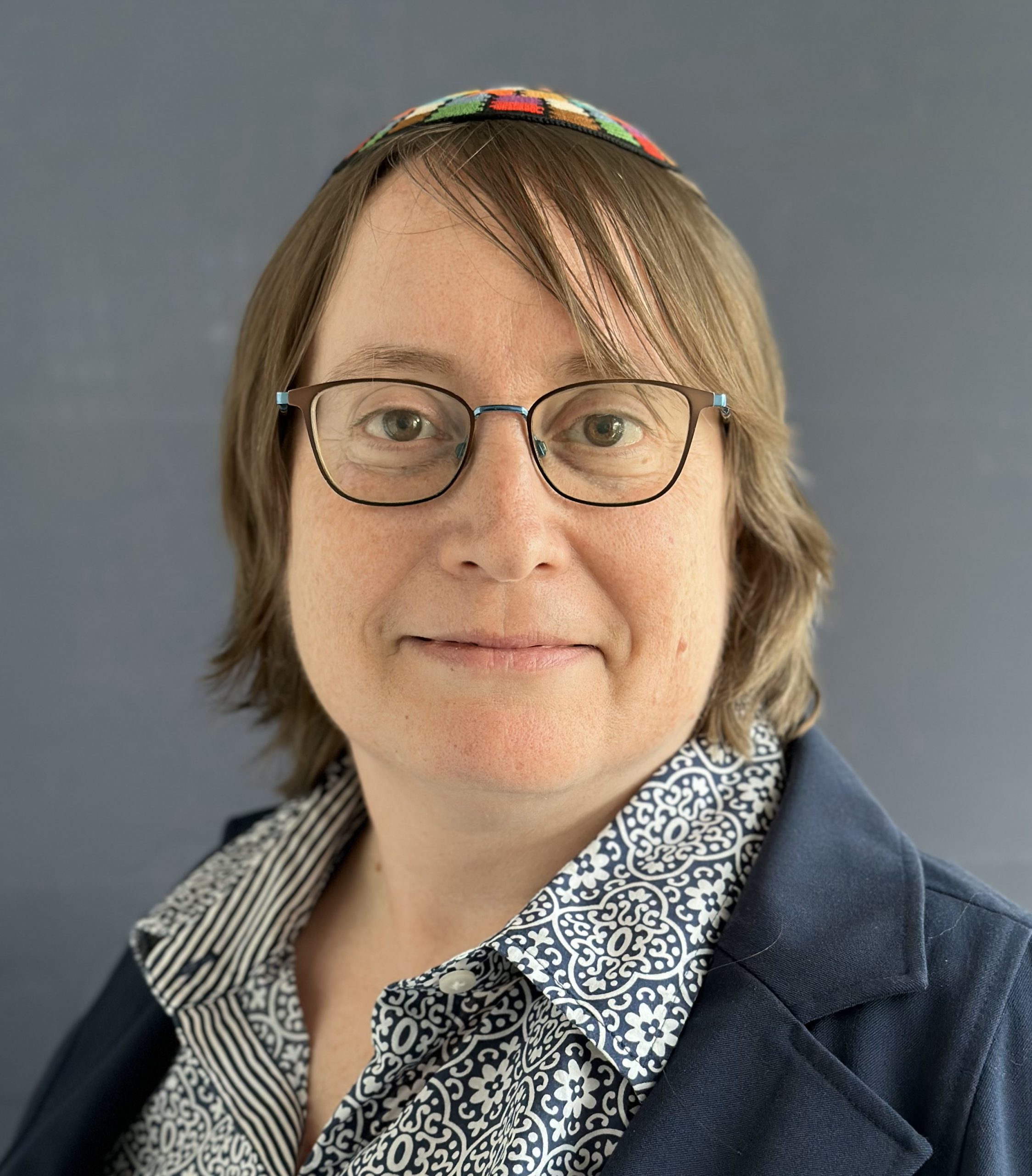 Rebecca's face - white woman, glasses, brown hair past shoulders