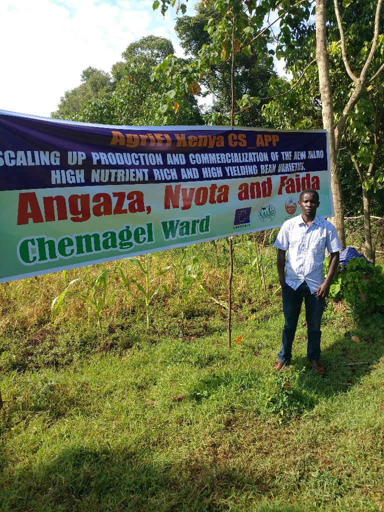 man in front of big banner/sign
